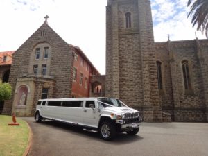 A brand new wedding Hummer outside of a church