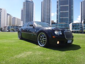 Black Chrysler Limo for Hire Parked in Grass