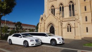 two wedding limos parked in front of a church in Mandurah