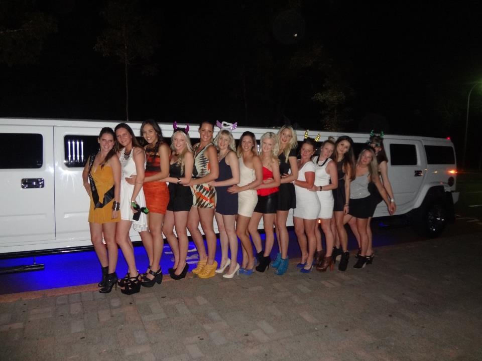 Group of Girls Posing in Front of White Limousine